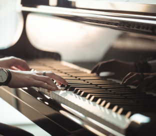 Woman playing a piano in music studio